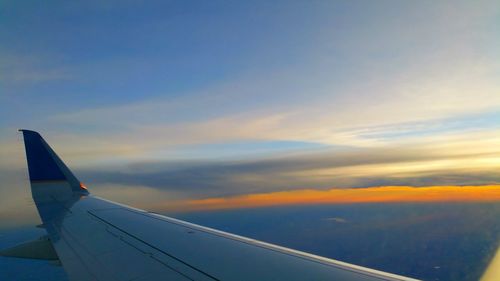 Cropped image of airplane flying in sky