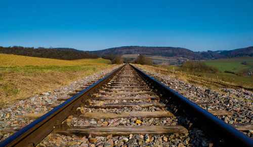 Railroad track against blue sky