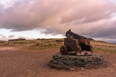 Rock formations on field against sky