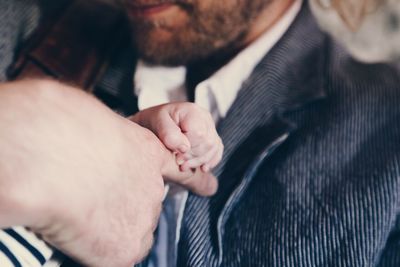 Close-up of human hand holding finger