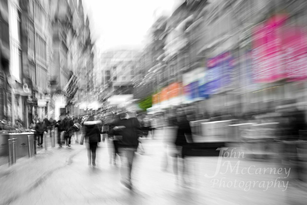 transportation, city, street, built structure, mode of transport, architecture, blurred motion, building exterior, city life, road, on the move, motion, the way forward, land vehicle, weather, walking, car, city street, incidental people