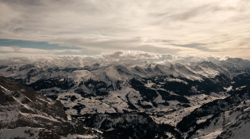 Scenic view of snowcapped mountains against sky