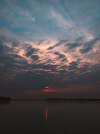 Scenic view of sea against romantic sky at sunset