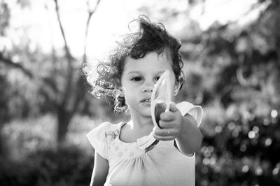 Portrait of girl holding plant