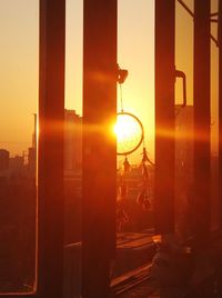 Close-up of illuminated city against sky during sunset