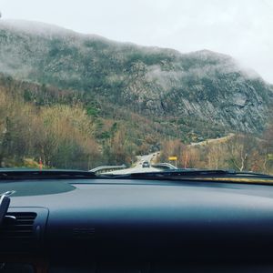 Close-up of car on mountains against sky