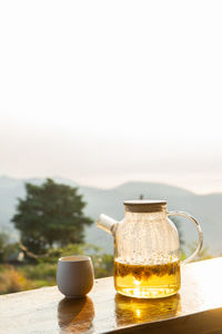 Close-up of tea cup on table against sky