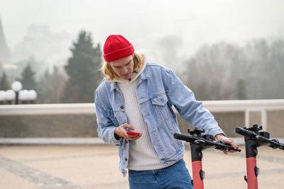 Rear view of woman standing by railing