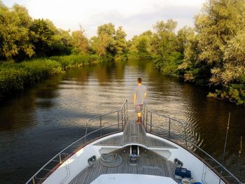 Reflection of trees in lake against sky. fishman  on the yacht.