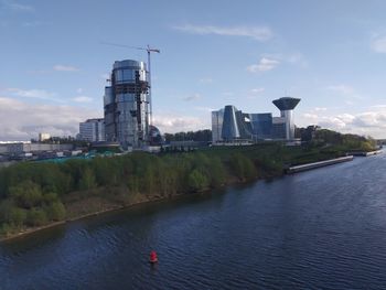 River amidst buildings against sky