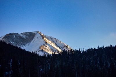 Scenic view of snowcapped mountains against clear blue sky
