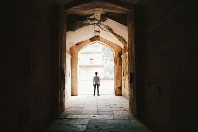 Rear view of man standing in corridor at vijayraghavgarh fort