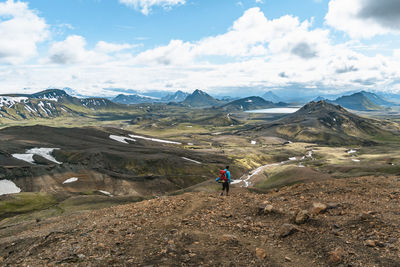 Backpacker immersed in alftavatn valley