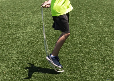 Low section of man standing on grass