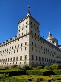 Low angle view of building against clear blue sky