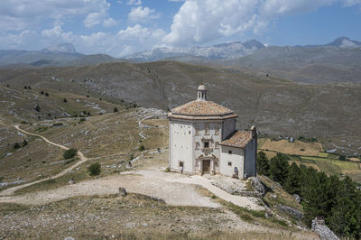 The church of santa maria della pietà in rocca calascio with the beautiful abruzzo mountains