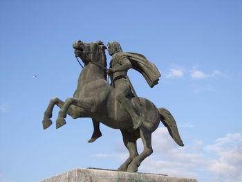 Low angle view of statue against blue sky