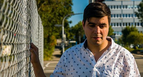 Portrait of man upset man near fence