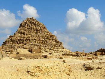 Ruins of temple against cloudy sky