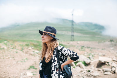 Young woman standing on field