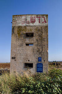 Exterior of old building against clear blue sky