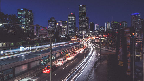 Cars and light trails on city street at night