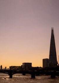 View of buildings at waterfront during sunset