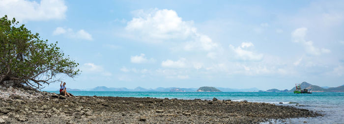 Scenic view of sea against cloudy sky