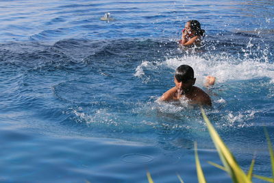 People swimming in river