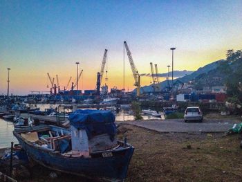 Boats in sea at sunset