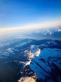 Aerial view of snowcapped mountains against sky