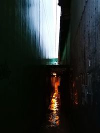 Illuminated bridge amidst buildings against sky in city