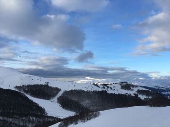 Scenic view of snow mountains against sky