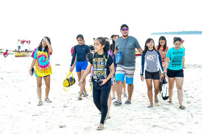 Friends standing on beach