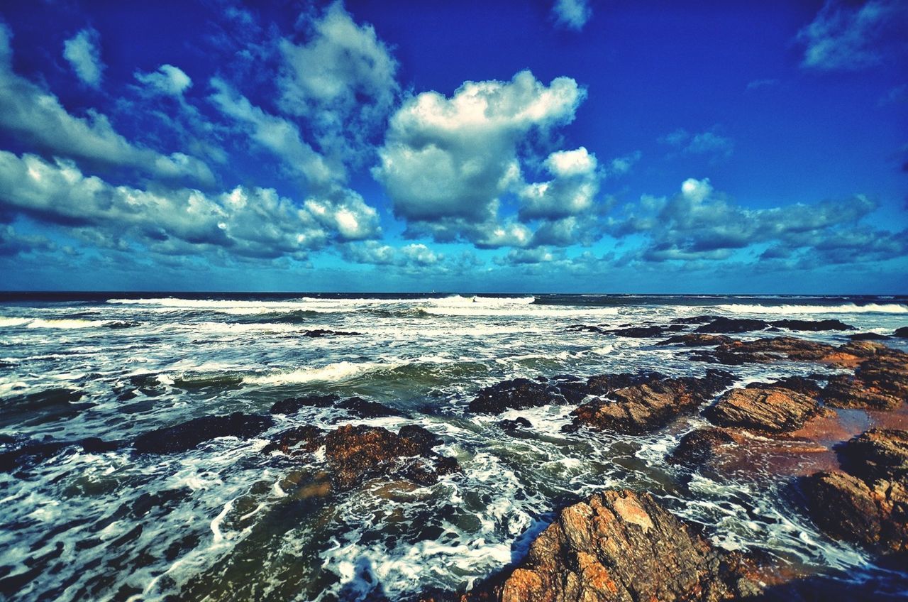 sea, horizon over water, water, sky, scenics, tranquil scene, beauty in nature, beach, cloud - sky, tranquility, blue, shore, nature, wave, cloud, cloudy, idyllic, rock - object, surf, outdoors