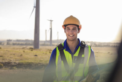 Portrait of smiling technician on a wind farm