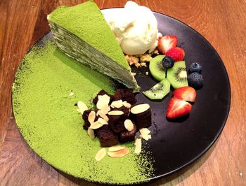 High angle view of chopped fruits in plate on table