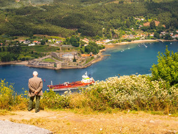 Rear view of man standing by river