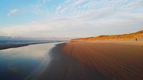 Scenic view of beach against sky during sunset