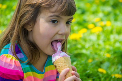 Close-up of girl blowing flowers