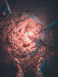 Low section of man standing by bonfire