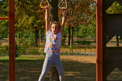 Full length of young woman standing in park