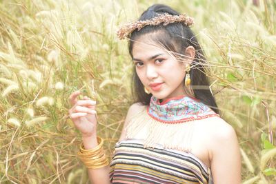 Portrait of smiling young woman lying on field