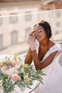 Close-up of woman with pink flowers