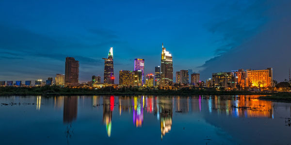 Reflection of illuminated buildings in city at night