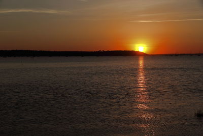 Scenic view of sea against romantic sky at sunset