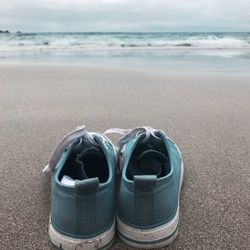 Close-up of sea shore at beach against sky