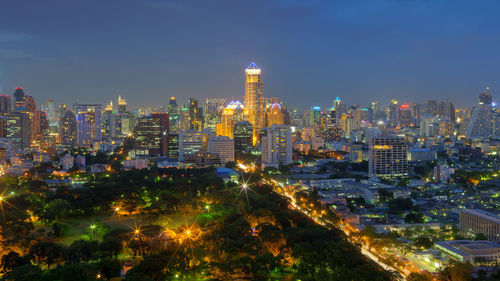 Illuminated buildings in city against sky