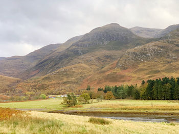 Scenic view of landscape and mountains against sky