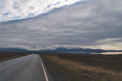 Road by landscape against sky